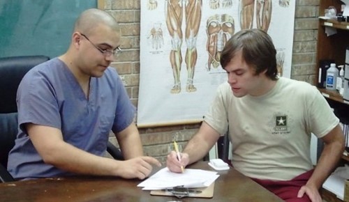 Elliott Marcott talking with massage therapist